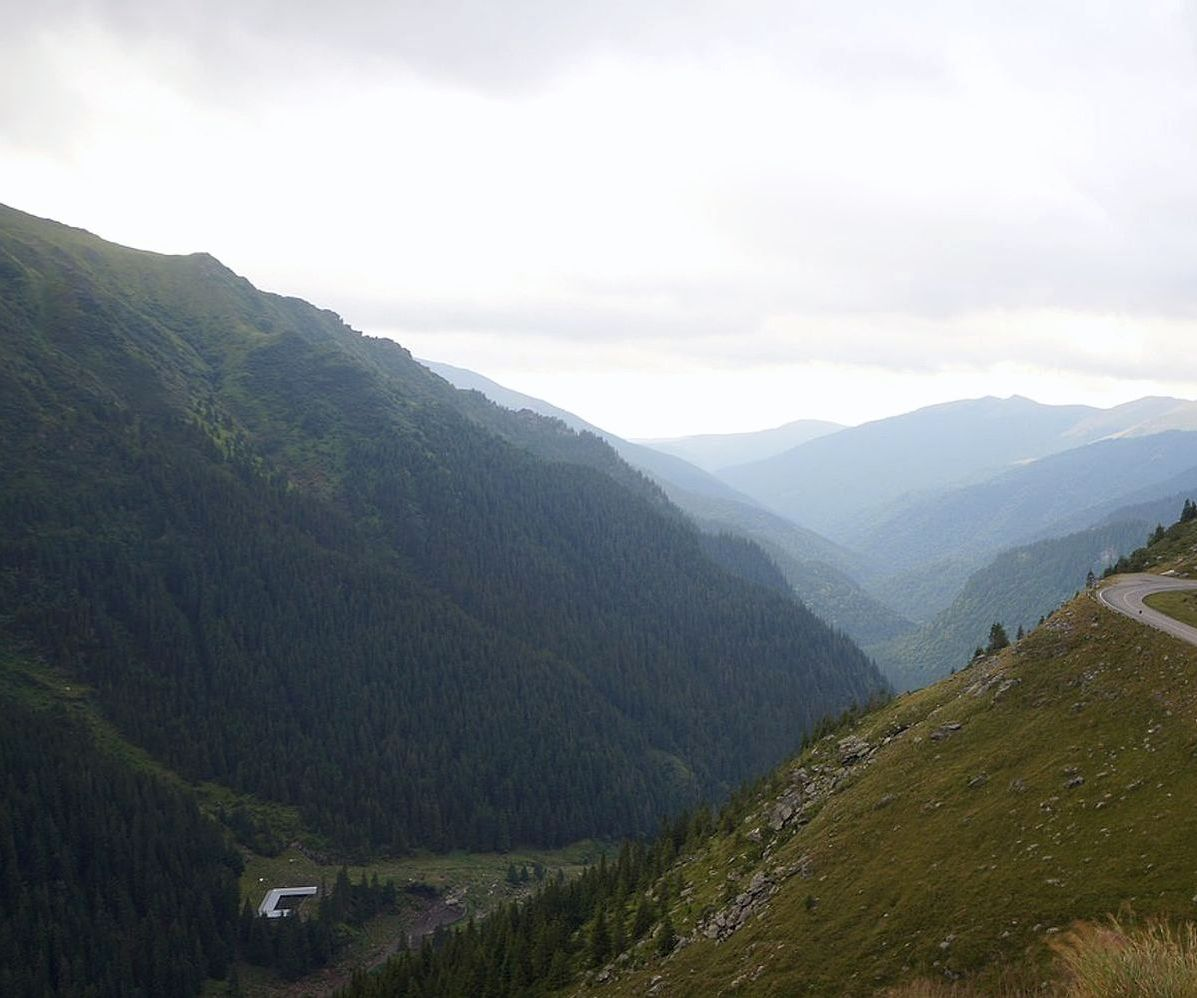 Riders ascending toward the clouds at the peak